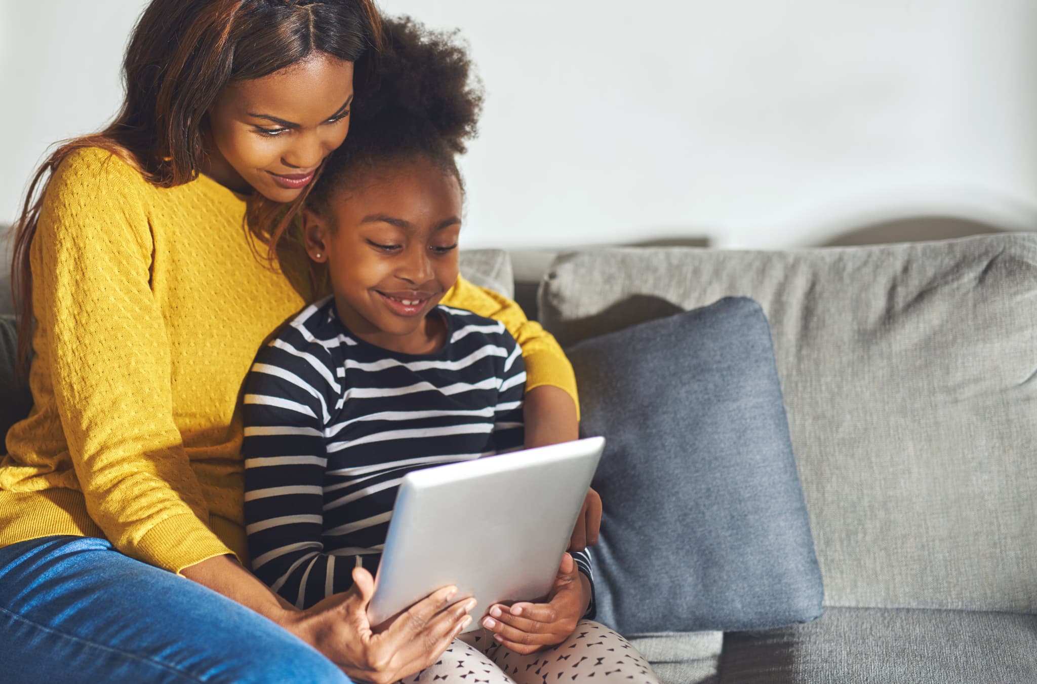 Parent and child using educational reading program at home following tutor recommendations